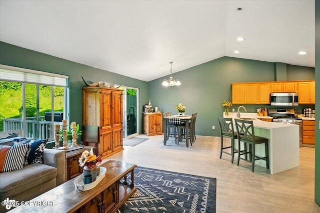 11437 Spyglass Hill Cir, Anchorage, AK 99515 - living area with a chandelier, vaulted ceiling, recessed lighting, and light wood finished floors