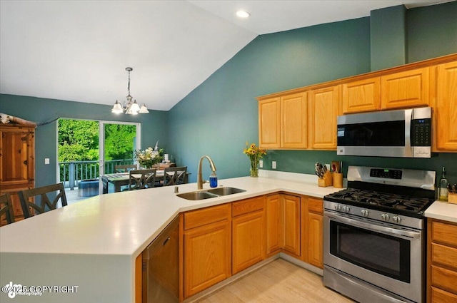 11437 Spyglass Hill Cir, Anchorage, AK 99515 - kitchen with stainless steel appliances, vaulted ceiling, a peninsula, light countertops, and a chandelier