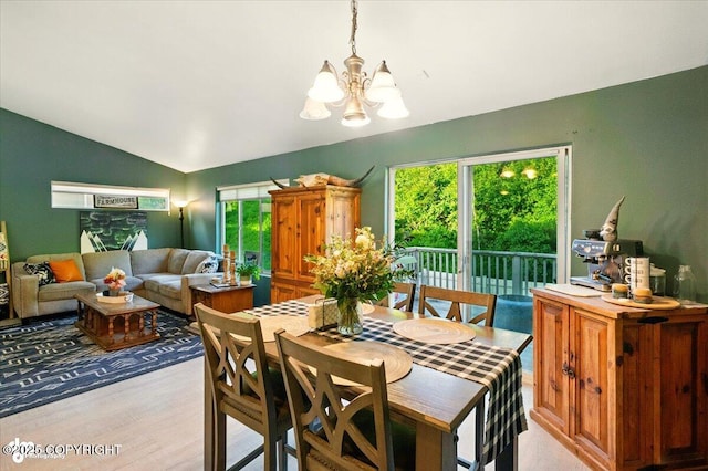 11437 Spyglass Hill Cir, Anchorage, AK 99515 - dining room featuring a chandelier, vaulted ceiling, and light wood-type flooring