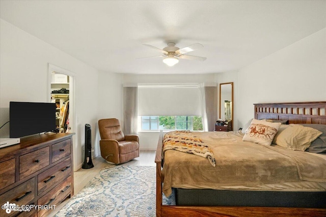 11437 Spyglass Hill Cir, Anchorage, AK 99515 - bedroom with a walk in closet, light wood finished floors, and ceiling fan