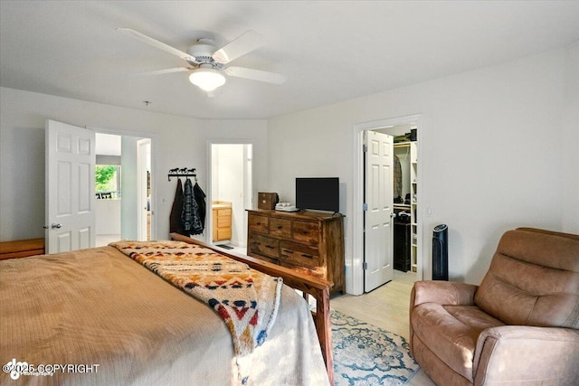 11437 Spyglass Hill Cir, Anchorage, AK 99515 - bedroom with a spacious closet, light wood-style floors, a closet, a ceiling fan, and ensuite bathroom