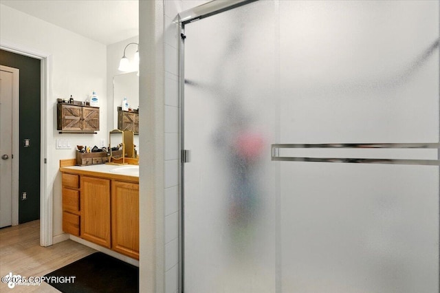 11437 Spyglass Hill Cir, Anchorage, AK 99515 - bathroom with vanity, wood finished floors, and a stall shower