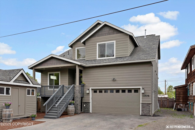 1506 M St, Anchorage, AK 99501 - view of front of property featuring a garage, covered porch, driveway, a shingled roof, and stone siding
