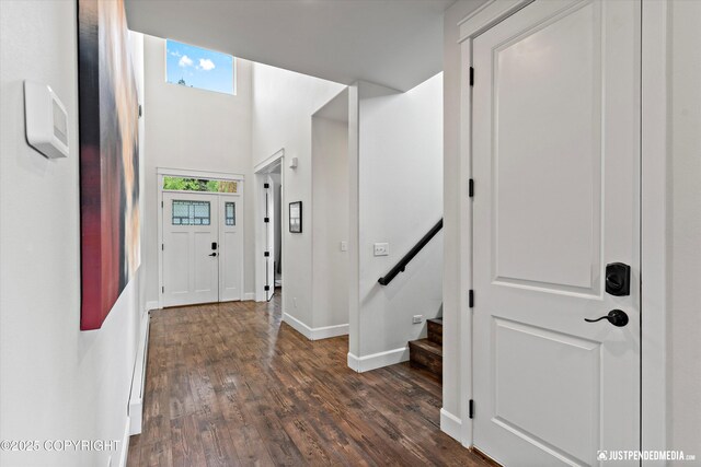1506 M St, Anchorage, AK 99501 - foyer with dark wood-type flooring, baseboards, and stairway