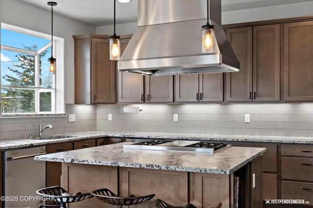 1506 M St, Anchorage, AK 99501 - kitchen featuring range hood, stainless steel appliances, a sink, and decorative backsplash