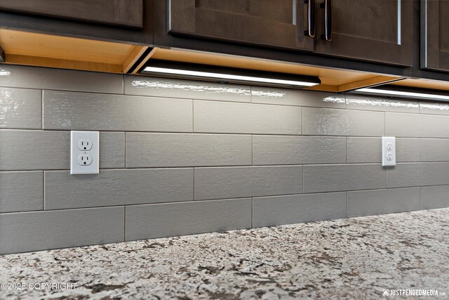 1506 M St, Anchorage, AK 99501 - kitchen view of dark brown cabinets, light stone countertops, and decorative backsplash