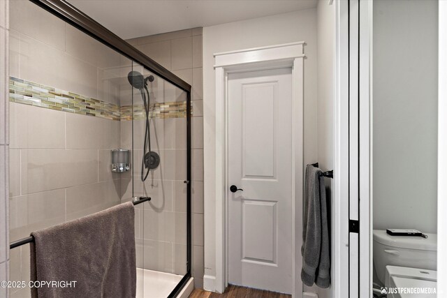 1506 M St, Anchorage, AK 99501 - bathroom featuring a shower stall, toilet, and wood finished floors