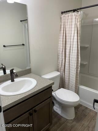 1506 M St, Anchorage, AK 99501 - bathroom featuring wood finished floors, vanity, toilet, and shower / bath combination with curtain