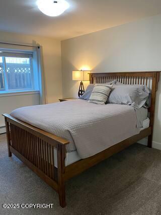 1506 M St, Anchorage, AK 99501 - carpeted bedroom with baseboard heating