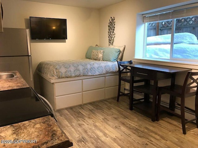 1506 M St, Anchorage, AK 99501 - bedroom with light wood finished floors and freestanding refrigerator