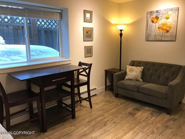 1506 M St, Anchorage, AK 99501 - living area with light wood-style floors, healthy amount of natural light, and baseboards