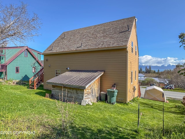 124 Mountain View Dr, Homer, AK 99603 - view of home's exterior with a yard and roof with shingles