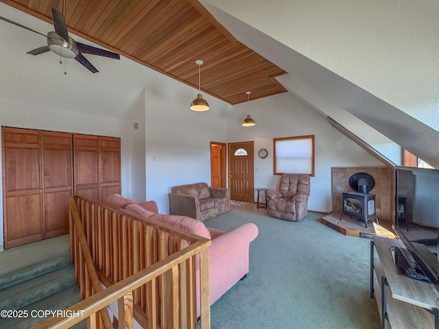 124 Mountain View Dr, Homer, AK 99603 - carpeted living area featuring wood ceiling, a ceiling fan, a wood stove, and high vaulted ceiling
