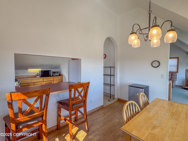 124 Mountain View Dr, Homer, AK 99603 - dining room with arched walkways, wood finished floors, and high vaulted ceiling