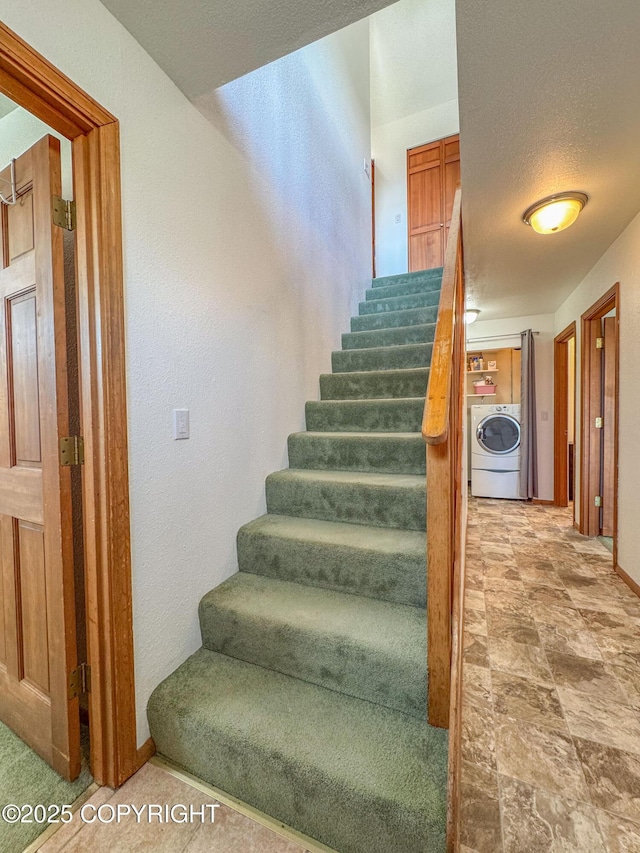 124 Mountain View Dr, Homer, AK 99603 - stairs with washer / clothes dryer, stone finish flooring, baseboards, and a textured wall