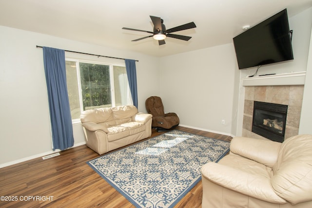 3208 E Serendipity Loop, Wasilla, AK 99654 - living room with wood finished floors, ceiling fan, a fireplace, and baseboards