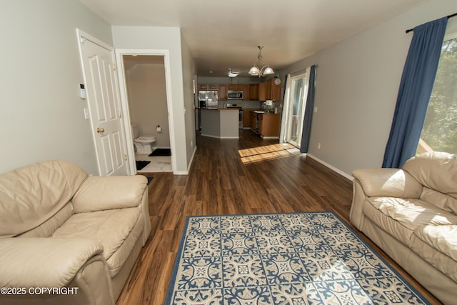 3208 E Serendipity Loop, Wasilla, AK 99654 - living room with a chandelier, dark wood-type flooring, and baseboards