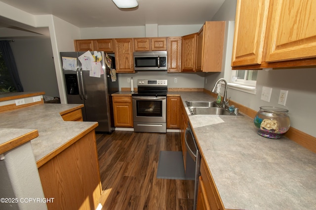 3208 E Serendipity Loop, Wasilla, AK 99654 - kitchen with appliances with stainless steel finishes, a sink, dark wood-style floors, light countertops, and brown cabinets