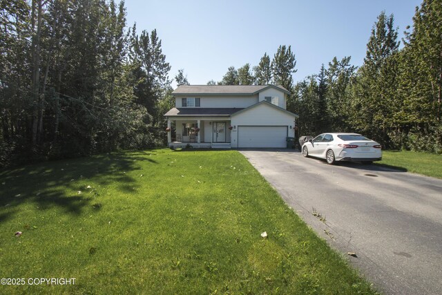3208 E Serendipity Loop, Wasilla, AK 99654 - traditional-style house with a porch, a front yard, an attached garage, and driveway