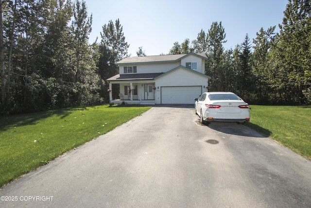 3208 E Serendipity Loop, Wasilla, AK 99654 - traditional-style home featuring asphalt driveway, a porch, a front lawn, and an attached garage