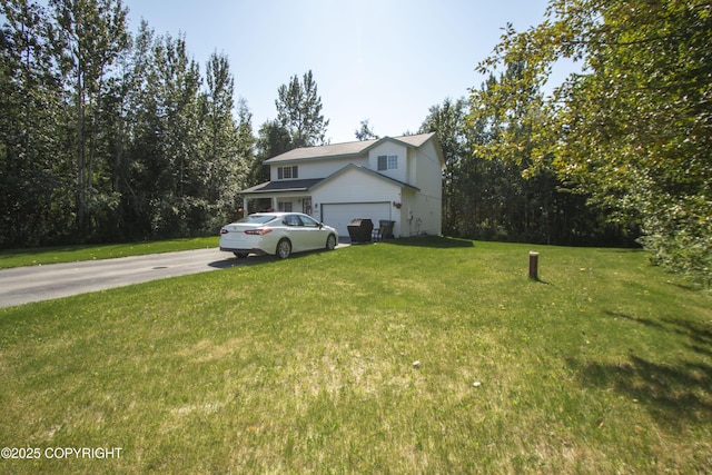 3208 E Serendipity Loop, Wasilla, AK 99654 - view of home's exterior featuring driveway, a lawn, and an attached garage