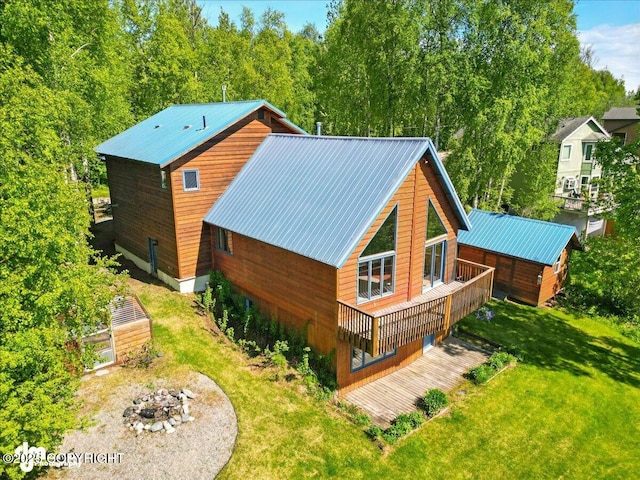 5680 W Birch Harbor Dr, Wasilla, AK 99623 - rear view of house with a fire pit, a yard, metal roof, and a deck