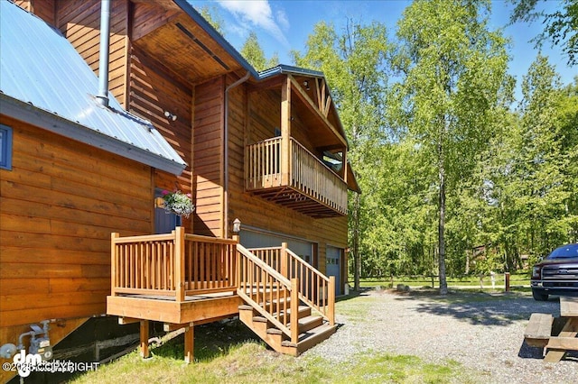 5680 W Birch Harbor Dr, Wasilla, AK 99623 - view of home's exterior featuring a balcony, an attached garage, and metal roof