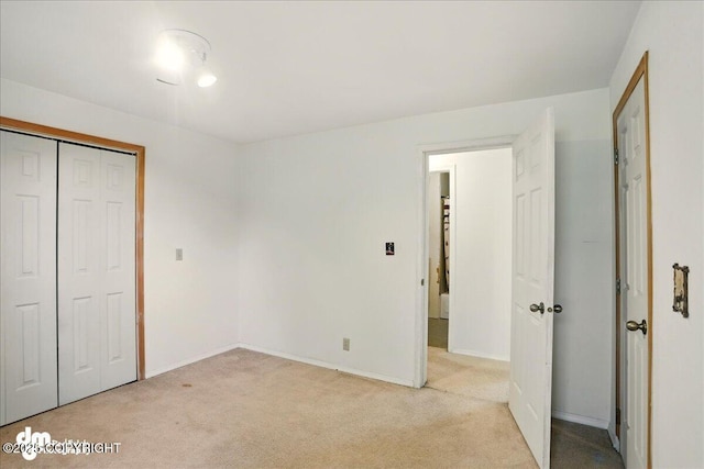 5680 W Birch Harbor Dr, Wasilla, AK 99623 - unfurnished bedroom featuring light carpet, a closet, and baseboards