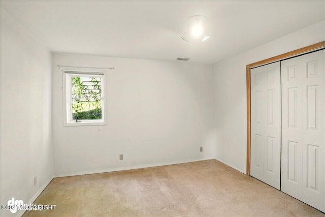 5680 W Birch Harbor Dr, Wasilla, AK 99623 - unfurnished bedroom with light colored carpet, a closet, and baseboards