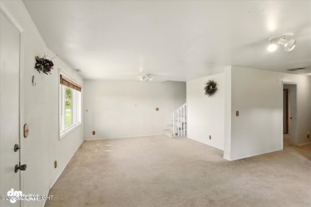5680 W Birch Harbor Dr, Wasilla, AK 99623 - unfurnished room with light carpet, stairway, and baseboards