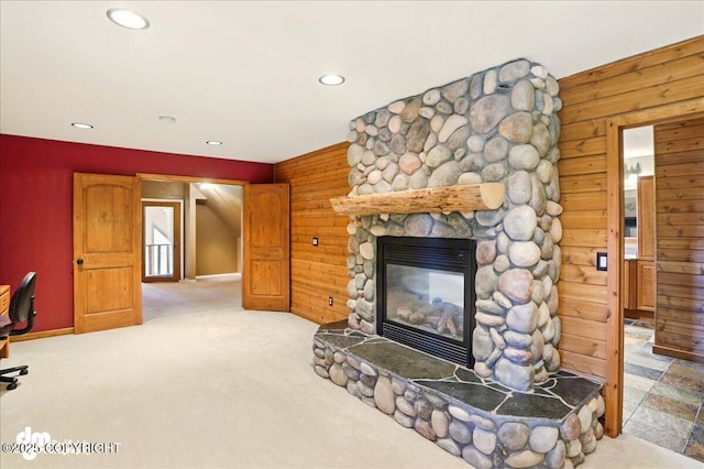 5680 W Birch Harbor Dr, Wasilla, AK 99623 - unfurnished living room featuring recessed lighting, wooden walls, a fireplace, carpet, and baseboards