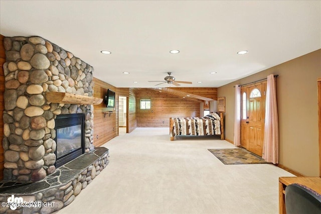 5680 W Birch Harbor Dr, Wasilla, AK 99623 - unfurnished living room featuring wood walls, carpet flooring, plenty of natural light, a ceiling fan, and recessed lighting