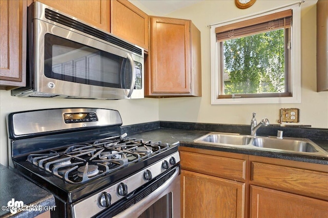 5680 W Birch Harbor Dr, Wasilla, AK 99623 - kitchen with appliances with stainless steel finishes, a sink, and dark countertops