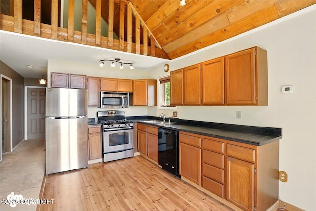 5680 W Birch Harbor Dr, Wasilla, AK 99623 - kitchen with appliances with stainless steel finishes, lofted ceiling, dark countertops, a sink, and light wood-style floors
