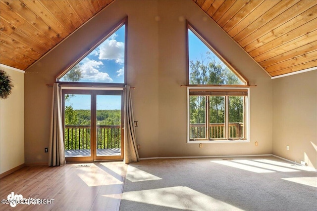 5680 W Birch Harbor Dr, Wasilla, AK 99623 - unfurnished living room featuring wood ceiling, baseboards, high vaulted ceiling, and wood finished floors