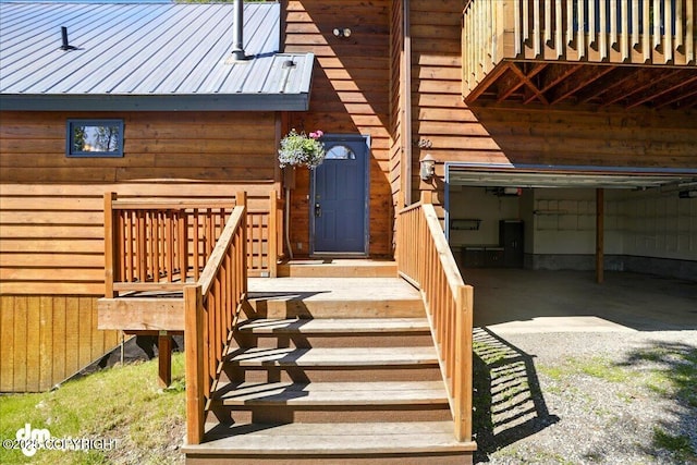 5680 W Birch Harbor Dr, Wasilla, AK 99623 - doorway to property featuring metal roof and an attached garage