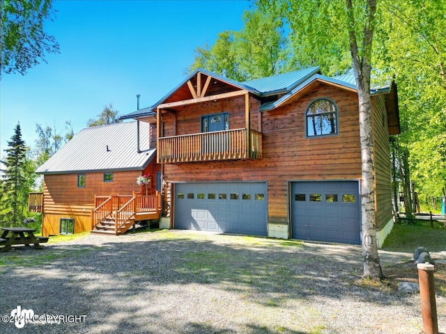 5680 W Birch Harbor Dr, Wasilla, AK 99623 - view of front of home featuring a garage, metal roof, and gravel driveway