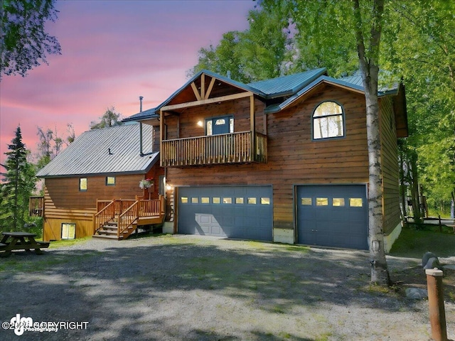 5680 W Birch Harbor Dr, Wasilla, AK 99623 - view of front of property with a garage, metal roof, and driveway