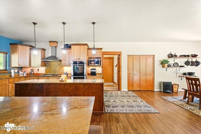 6325 S Hayfield Rd, Wasilla, AK 99654 - kitchen with wall chimney exhaust hood, appliances with stainless steel finishes, dark wood-type flooring, tasteful backsplash, and stone countertops