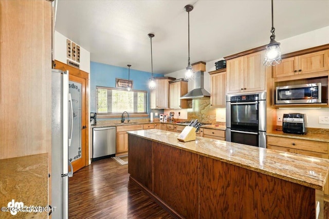 6325 S Hayfield Rd, Wasilla, AK 99654 - kitchen with stainless steel appliances, wall chimney range hood, a sink, dark wood-style floors, and light stone counters