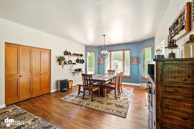6325 S Hayfield Rd, Wasilla, AK 99654 - dining area with a chandelier, baseboards, and dark wood-style flooring