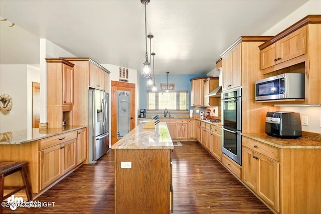 6325 S Hayfield Rd, Wasilla, AK 99654 - kitchen with appliances with stainless steel finishes, a kitchen island, dark wood finished floors, and under cabinet range hood