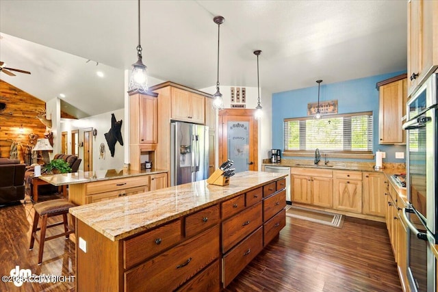 6325 S Hayfield Rd, Wasilla, AK 99654 - kitchen with stainless steel appliances, a sink, open floor plan, dark wood-type flooring, and light stone counters