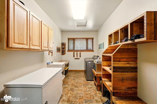 6325 S Hayfield Rd, Wasilla, AK 99654 - laundry room with separate washer and dryer, cabinet space, stone finish floors, and baseboards