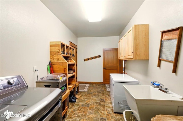 6325 S Hayfield Rd, Wasilla, AK 99654 - washroom with cabinet space, washer and clothes dryer, stone finish floors, and baseboards