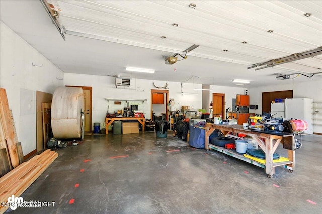 6325 S Hayfield Rd, Wasilla, AK 99654 - garage featuring a workshop area, a garage door opener, freestanding refrigerator, and a heating unit