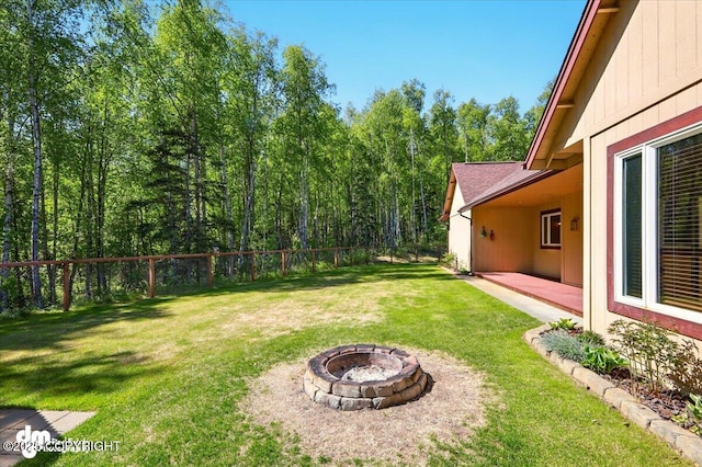 6325 S Hayfield Rd, Wasilla, AK 99654 - view of yard with a fire pit, a patio area, and a view of trees