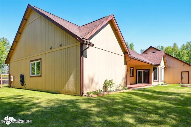 6325 S Hayfield Rd, Wasilla, AK 99654 - rear view of house with a shingled roof and a lawn