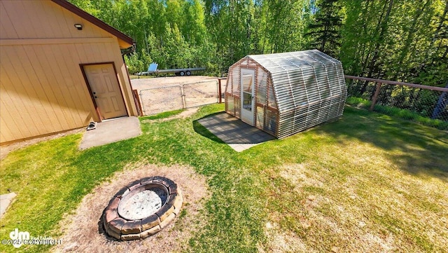 6325 S Hayfield Rd, Wasilla, AK 99654 - view of yard featuring an outdoor structure and a fire pit