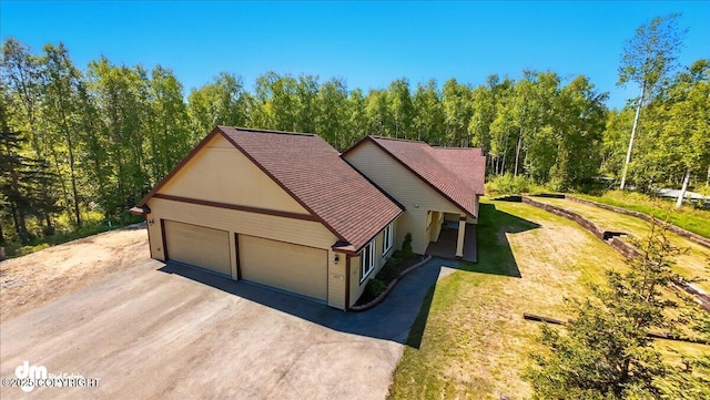 6325 S Hayfield Rd, Wasilla, AK 99654 - view of front of home with asphalt driveway, a front yard, roof with shingles, and a garage